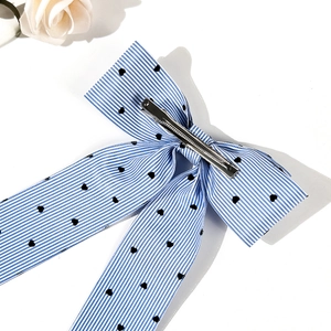 Blue and white striped bow hair clip with heart pattern and silver metal alligator grip