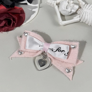 Gothic pink bow hair clip with silver heart charms and cross pendant detail