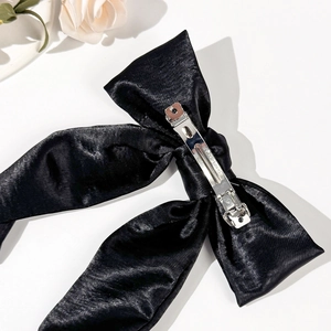 Elegant black satin bow hair clip with polished silver metal spring fastener