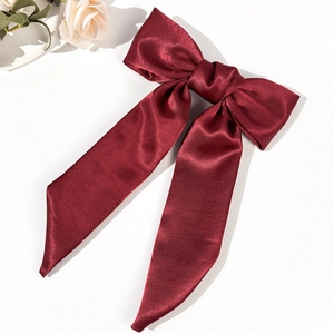 Elegant burgundy satin bow hair clip with long ribbons and a vintage French aesthetic