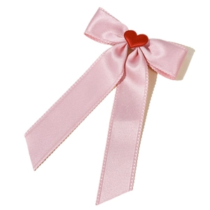 Elegant pink satin ribbon hair bow with a red heart center and long flowing streamers