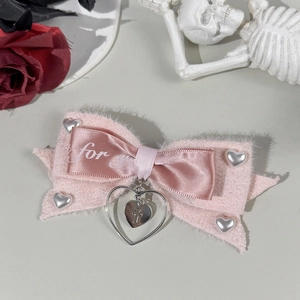 Gothic pink bow hair clip with heart pearls, cross pendant, and rose skull background