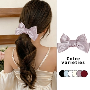 Detail showing high-quality satin bow hair clips in six elegant colors for women