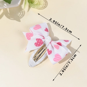 Detailed view of a white bow hair clip with pink hearts and 7.5cm size measurement