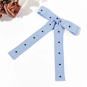 Blue and white striped bow hair clip with heart embroidery in a minimalist ballet style