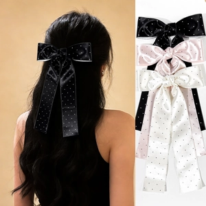 Elegant polka dot bow hair clips with long ribbons in black, pink, and white colors