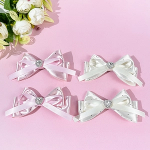 Pink and white satin bow hair clips set with polka dots and heart-shaped rhinestones