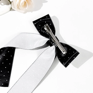 Elegant polka dot bow hair clip for women with black and white satin ribbon design