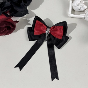 Gothic bow hair clip with silver skull and dagger pendant on red black ribbon
