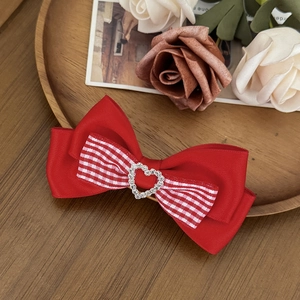 Japanese style red plaid bow hair clip with heart rhinestone on wooden tray