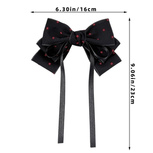 Detail view of red polka dot bow hair clip with 16x23cm dimensions on white background