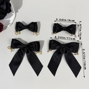 Gothic black satin bow hair clips set with gold heart and star charms ornaments