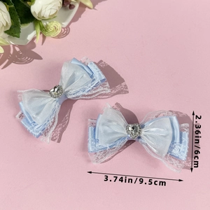 Close-up of blue lace heart bow hair clips with measurement details in 9.5cm size