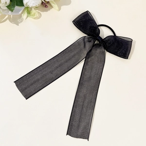 Detailed close-up of a black organza mesh hair scrunchie with long elegant ribbons