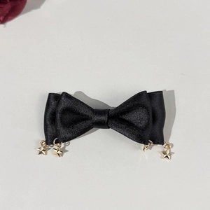 Gothic black satin bow hair clip featuring hanging gold star pendants for women