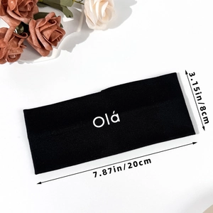 Elastic black sports headband with white Olá lettering for yoga and fitness use