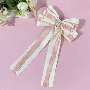 Elegant double-layered cream and pink bow hair clip with pearl and lace details