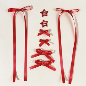 Detail view of red silk ballet ribbon bow clips and star-shaped hair accessories set