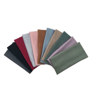 Close-up showing various colors of ribbed knit headbands with vertical stripe textures