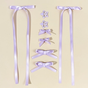 Detail view of 8-piece lavender hair accessory set with long ribbons and bow clips
