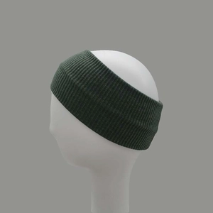 Detail of dark green ribbed knit headband showing elastic texture on model head