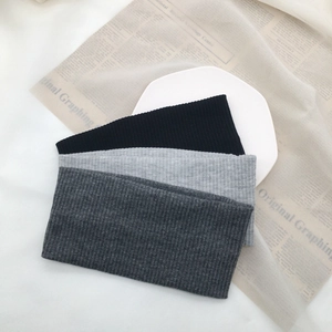 Detailed texture of three-piece ribbed knit headbands in black and grey tones