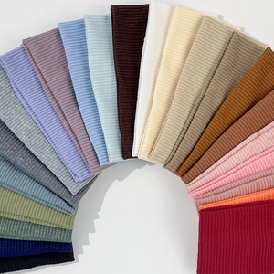 Elastic knitted headbands in multiple solid colors featuring vertical ribbed texture