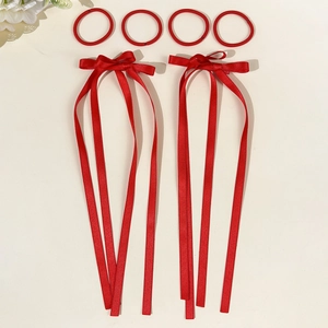 Set of six red satin hair accessories including long ribbon bows and elastic hair bands
