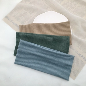 Detailed texture of ribbed knitted headbands in khaki, dark green, and grey-blue colors