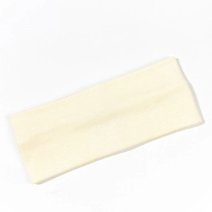 Close-up detail of the ribbed texture on a beige knitted yoga elastic headband