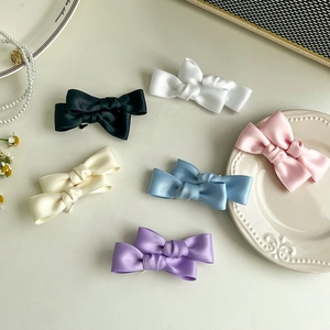 Japanese style satin double bow hair clips in six pastel colors with elegant silk texture