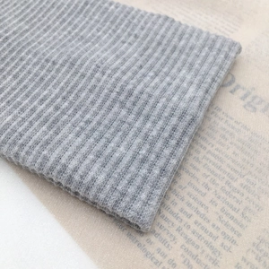 Detailed macro shot of grey ribbed knit fabric texture on a minimalist headband accessory