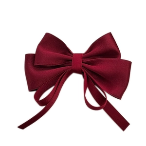 Elegant wine red multi-layer ribbon bow hair clip with streamers on a white background