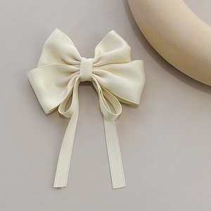 Elegant cream satin bow hair clip with long ribbons for women, minimalist aesthetic style
