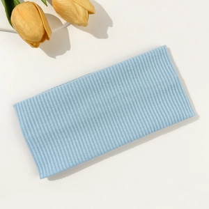 Detailed view of light blue ribbed knit headband with elastic texture and soft tulip decor