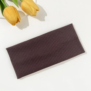 Detailed view of dark brown ribbed knit headband with high elastic fabric texture