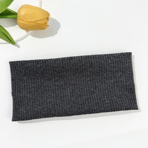 Detailed view of dark grey ribbed knit headband texture on a white background