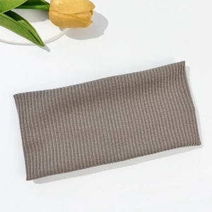 Detailed texture of brown ribbed knit headband with elastic wide-brim fabric design