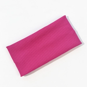 Macro shot of rose red knitted ribbed fabric texture for elastic sports headband