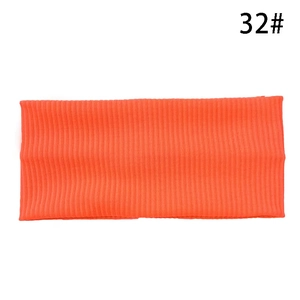 Detail of orange ribbed knit sports headband featuring high elasticity and vertical texture