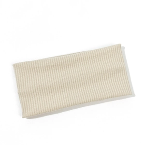 Macro detail of creamy white ribbed knit headband texture and high elastic fabric