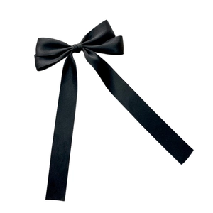 Elegant black satin bow hair clip with long ribbons on a clean white background