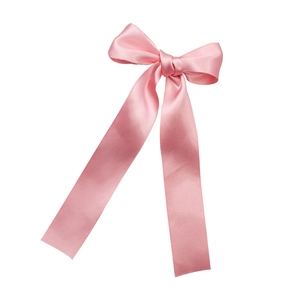 Elegant pink satin ballet bow hair clip with long ribbons on a clean white background