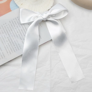 Elegant white satin double bow hair clip with a glossy finish for ballet style