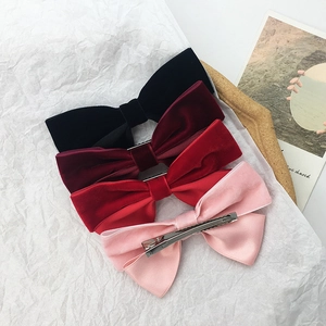 Set of four vintage velvet bow hair clips in black, burgundy, red and light pink