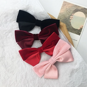 French retro velvet bow hair clips in four elegant colors on an aesthetic background