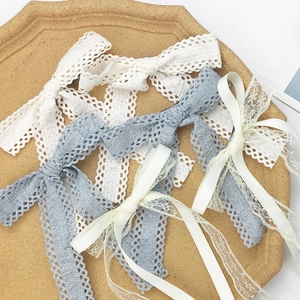 French retro lace bow hair clip set in white and grey-blue on a vintage textured tray