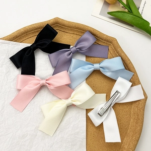 Set of 6 colorful satin bow hair clips for women in black, pink, blue, and white colors