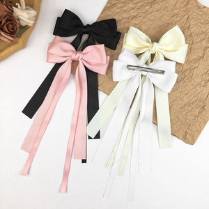 Elegant satin bow hair clips with long ribbons in black, pink, beige, and white colors