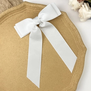 Elegant white grosgrain ribbon hair clip with long streamers in a sweet bow design